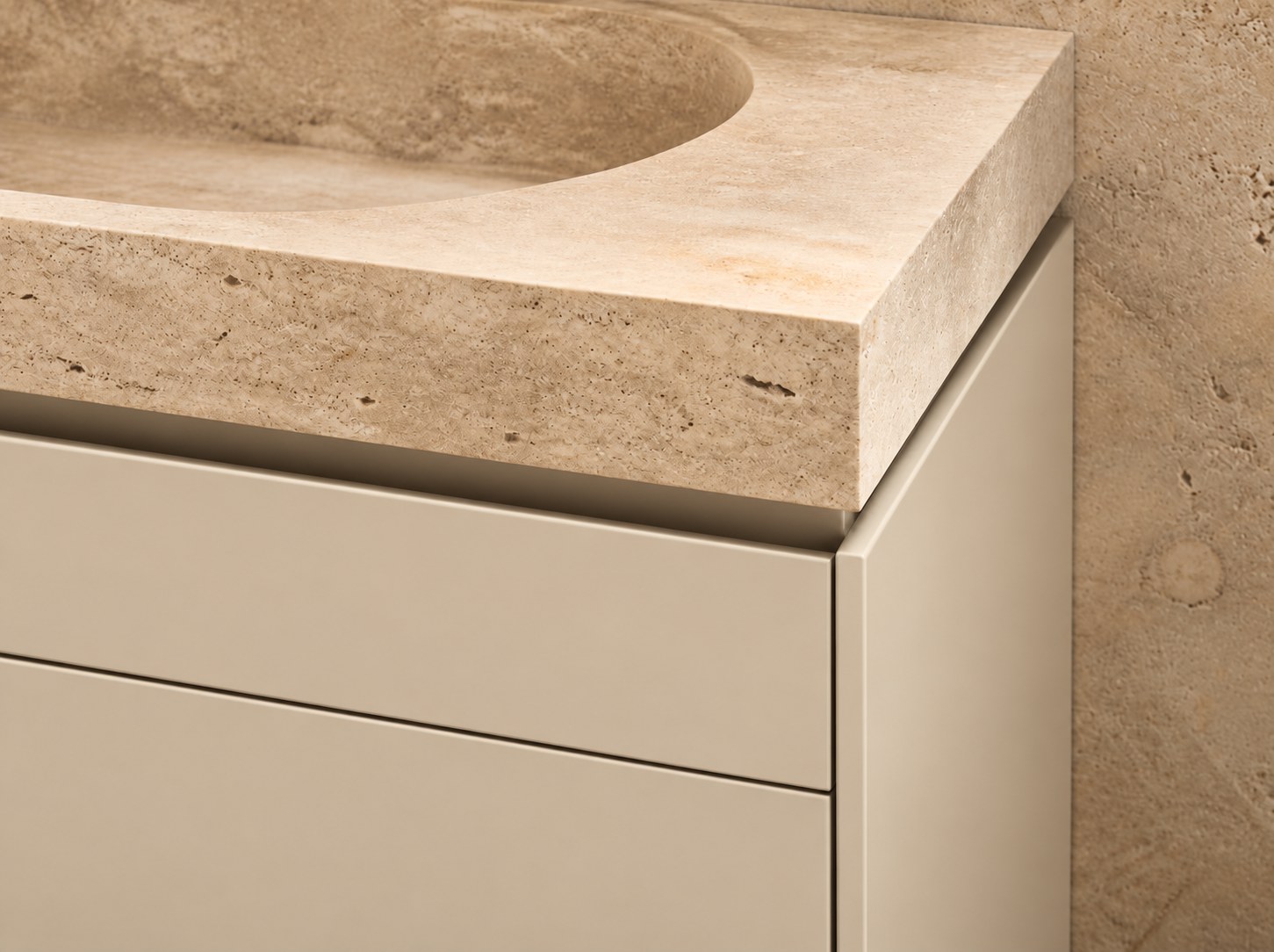 Carved stone integrated basin on sand-tone cabinetry