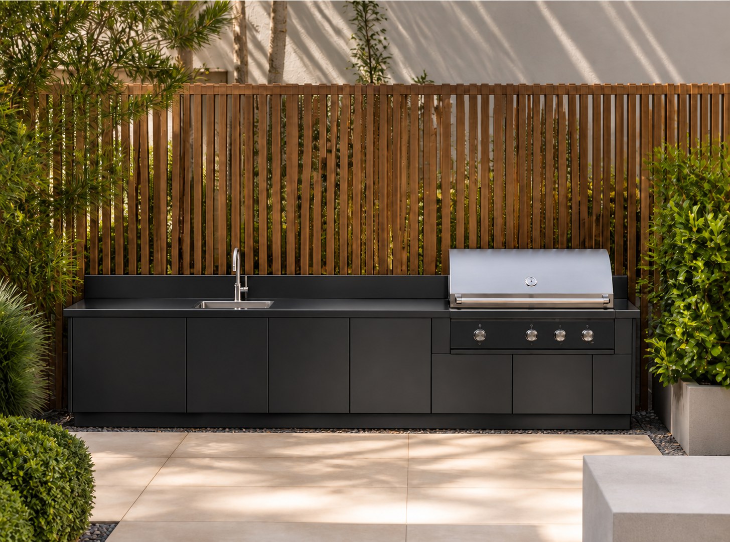 Matte black grill and sink module under pergola
